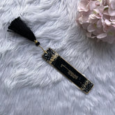 Black and gold Islamic personalized bookmark with Arabic calligraphy and black tassel, ideal for wedding favors or sacred book accessories.