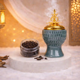 Jade Crown Bakhoor Burner with gold lid emitting smoke, paired with a jar of bakhoor, ideal for Ramadan & EID home decor and gifting.