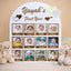 Personalized photo collage for a baby's first year with teddy bear and baby booties on a beige background.