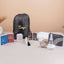 Labbaik Nisaa Women's Safar Essentials Kit featuring hijab, prayer mat, books, and grooming tools in a personalized drawstring bag for Hajj or Umrah.