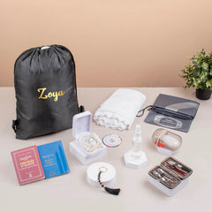Complete Labbaik Nisaa Women's Safar Essentials Kit displayed with hijab, tasbeeh, spray bottle, books, and grooming set for spiritual travel needs.