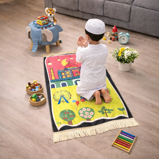 Kids Prayer Mat - Personalized Mat | Janamaz for Kids showing a child praying on a vibrant mat with mosque, Ferris wheel, and garden design.