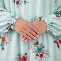 Detailed view of hands resting on Prayer Dress 6, emphasizing soft chiffon texture and elegant floral design.