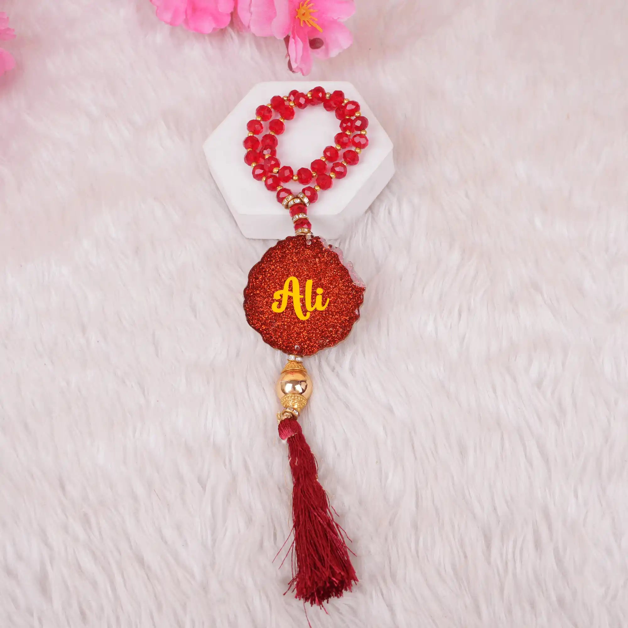 Red Kids Glitter Tasbeeh with 33 beads and custom 'Ali' name tag, includes a decorative tassel, great for religious occasions and gift delivery.