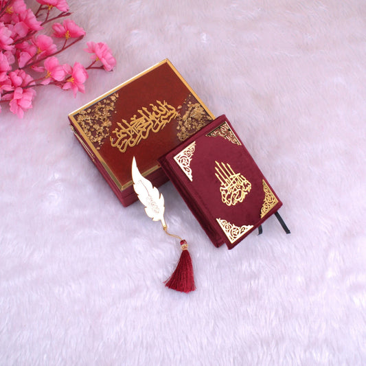 Mini Tilawat-e-Quran gift set in maroon velvet with gold detailing, includes a decorative feather bookmark and designer box. Ideal for weddings or gifting.