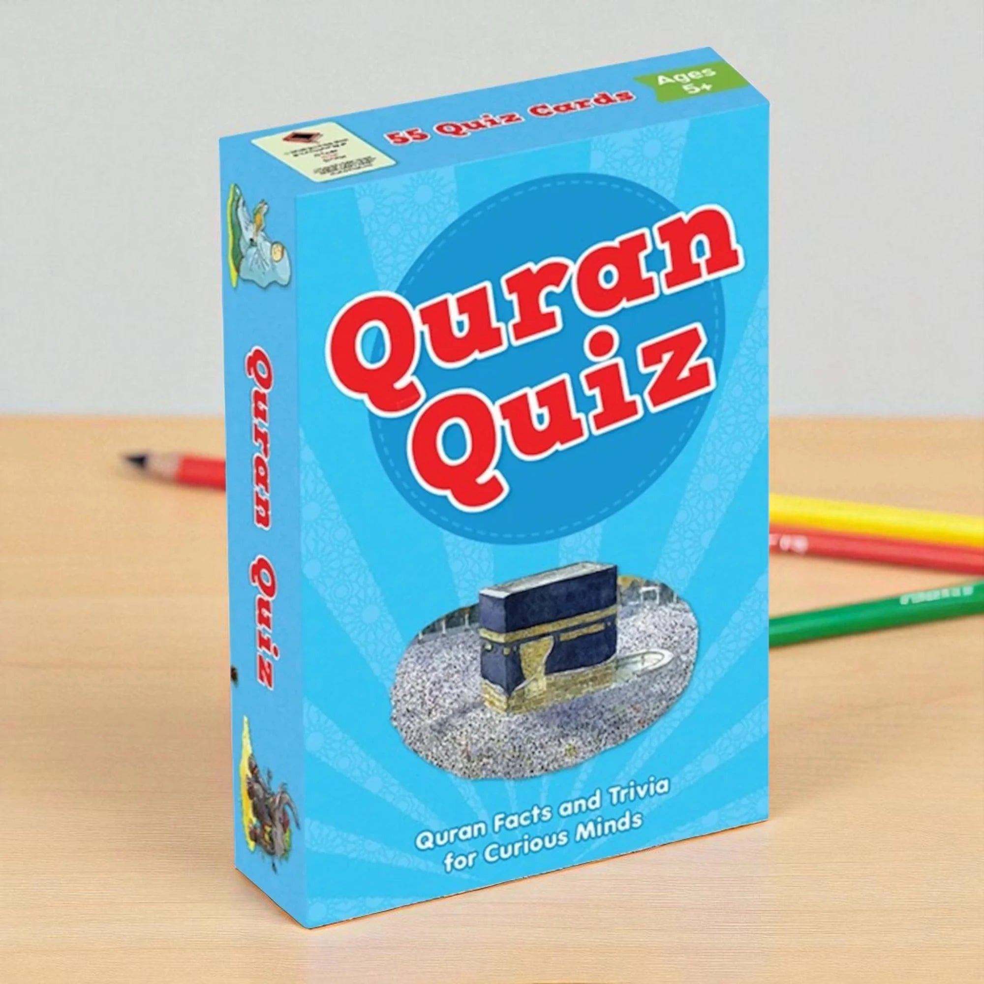 Quran Quiz packaging with a blue background and text on a wooden surface.