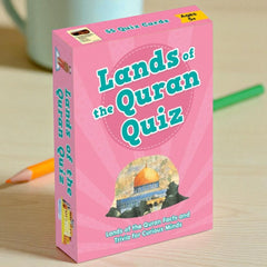 Pink box of 'Lands of the Quran Quiz' on a wooden surface with a green pencil.