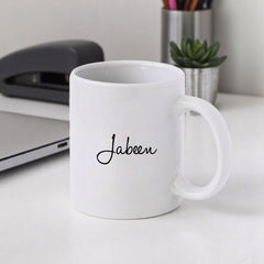 Custom white ceramic 350ml mug with the name 'Jabeen' in elegant script, part of Personalized Hajj Mubarak Mug - Welcome Back collection.