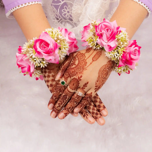 Handcrafted Pink Floral Gajra worn on wrists with intricate mehndi, ideal for bridal elegance and Haldi Mehndi wedding favors.