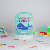 Children's book titled 'Prophet Yunus' with building blocks and crayons on a white surface