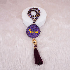 Kids Glitter Tasbeeh with 33 crystal beads in deep purple, featuring a personalized 'Sana' name tag and maroon tassel, ideal for Islamic gifts.