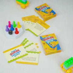Quran Explorer Game set with cards, dice, and colorful pieces on a white background