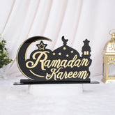 Decorative sign with 'Ramadan Kareem' text on a black base, featuring a moon and star design.