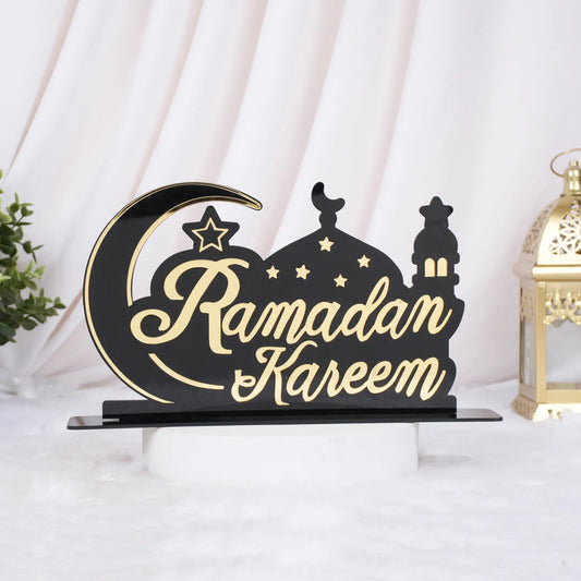 Decorative sign with 'Ramadan Kareem' text on a black base, featuring a moon and star design.