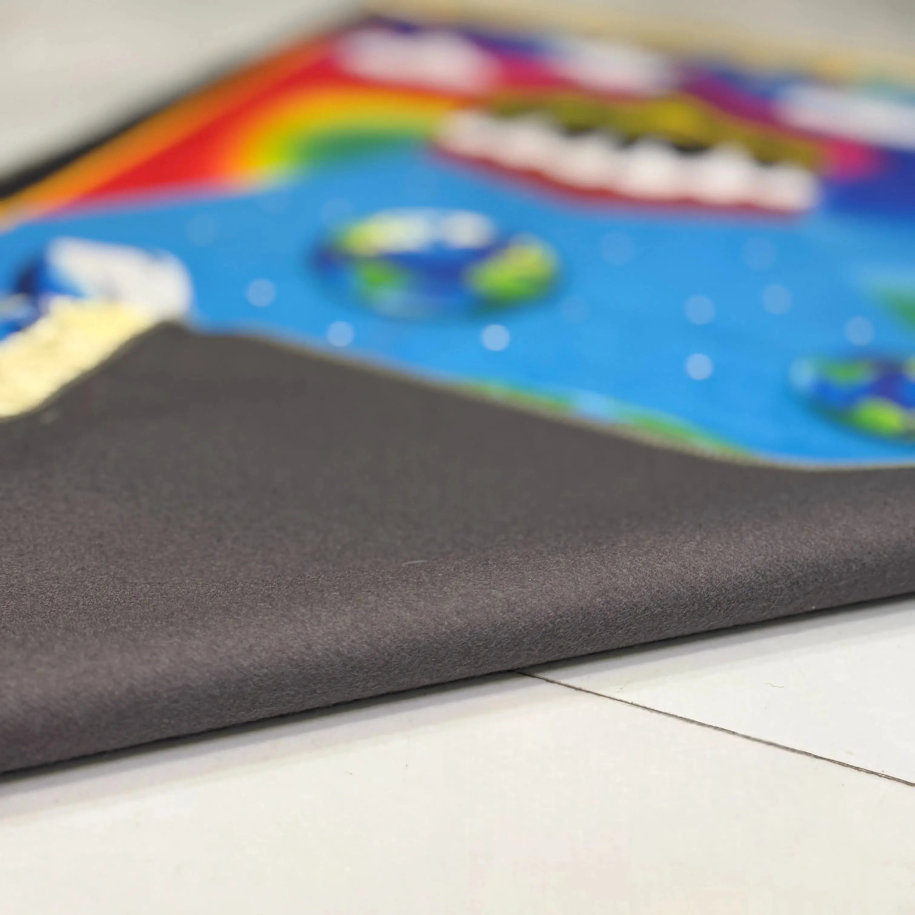 Close-up of the Rainbow Salah Joy Kids Janamaz showing soft, foldable fabric and vibrant print. Designed for comfort and portability in kids' prayer routines.