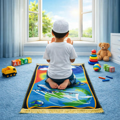 Kids Prayer Mat - Personalized Mat | Janamaz for Kids showing a child praying on a space-themed mat with airplane and globe design in a sunny room.