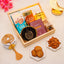 Gift basket with cookies, almonds, and a glass with 'Ramadan Mubarak' text on a light background.