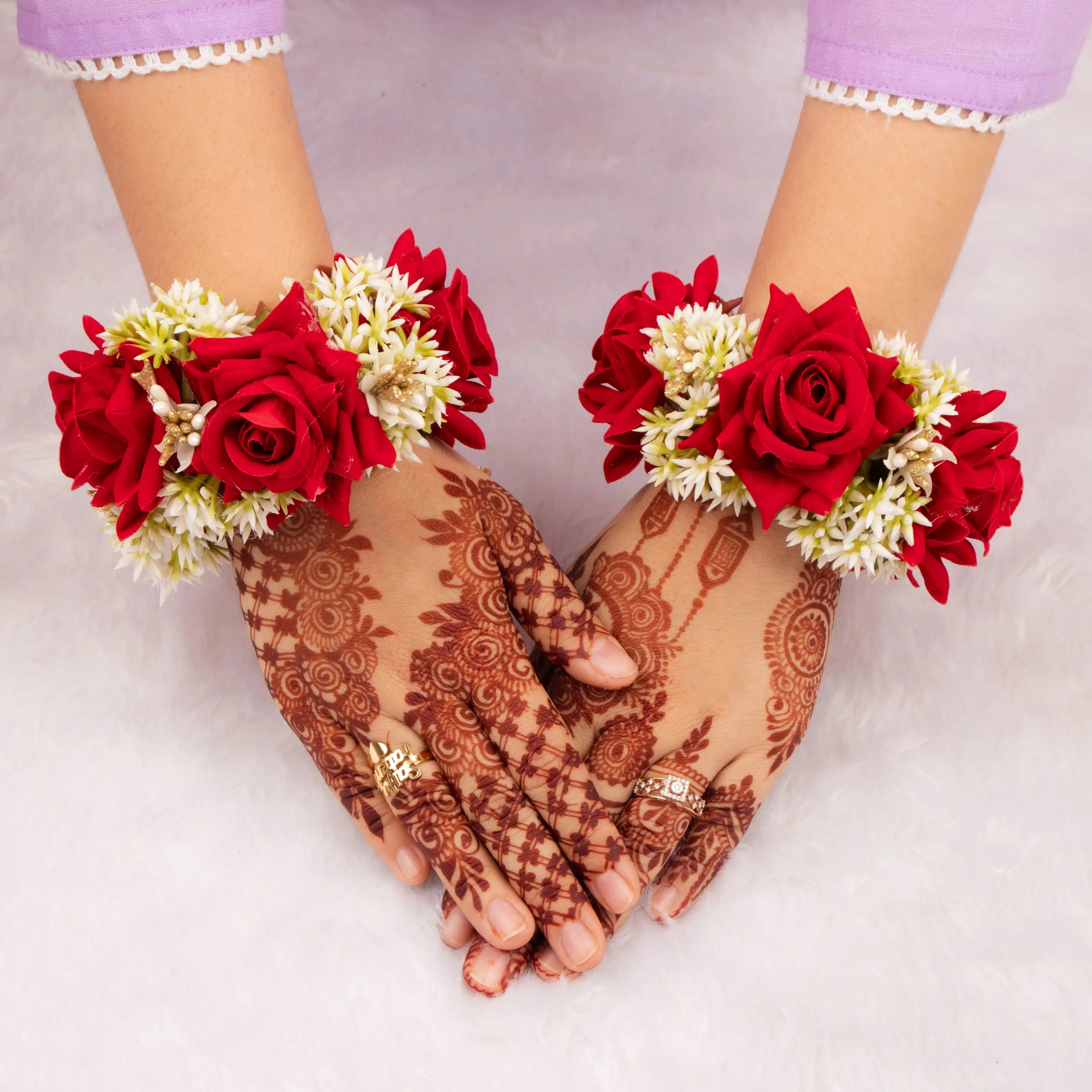 Handcrafted Red Floral Gajra with red roses and white buds worn on wrists, ideal for bridal accessories and wedding favors in traditional ceremonies.
