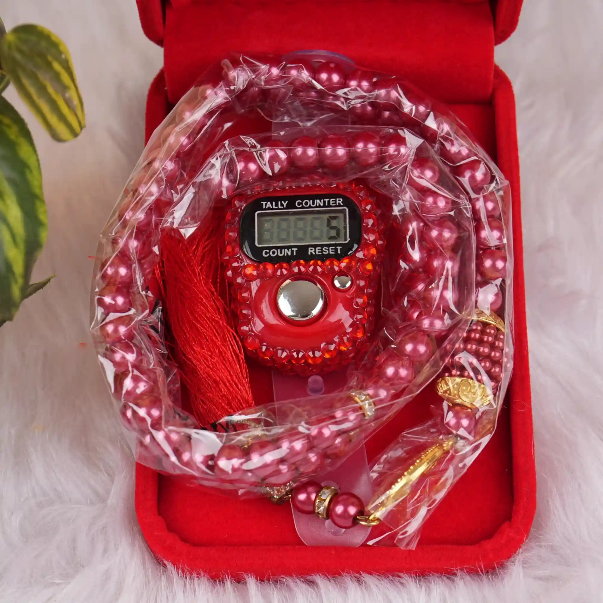 Close-up of Red Velvet Tasbeeh Combo showing digital counter and pearl tasbeeh inside a plush red velvet box. Elegant Dhikr tool for daily remembrance.