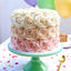 Heavenly Rose Cake with ombre rose pattern frosting in white, peach, and pink on a green cake stand. Ideal for weddings and anniversary gifts.