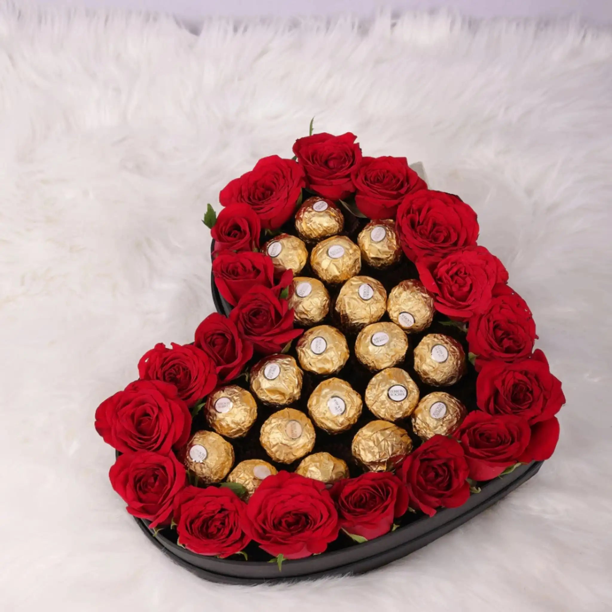 Sweetheart Symphony - Roses & Rochers Set featuring 20 red roses and 20 Ferrero Rochers arranged on a heart-shaped base. Ideal romantic gift.