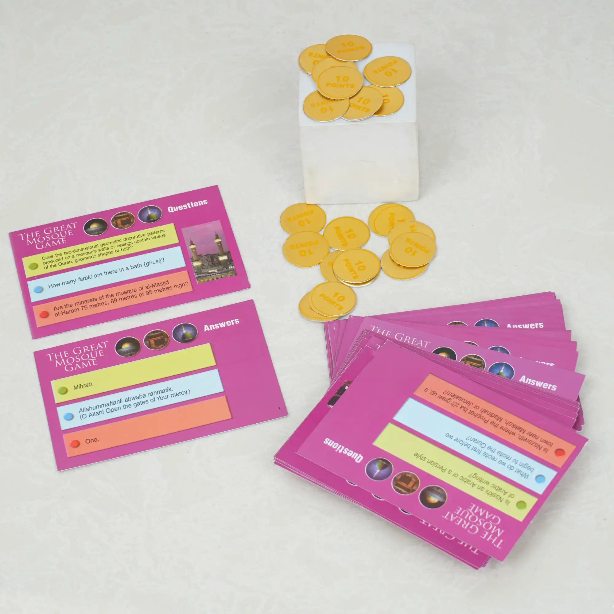 Card game components including question cards, answer cards, and yellow game pieces on a white background