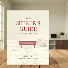 The Seeker's Guide - Pocket Edition by Maulana Wahiduddin Khan, a compact educational board book for kids aged 0-5, placed on a wooden table.