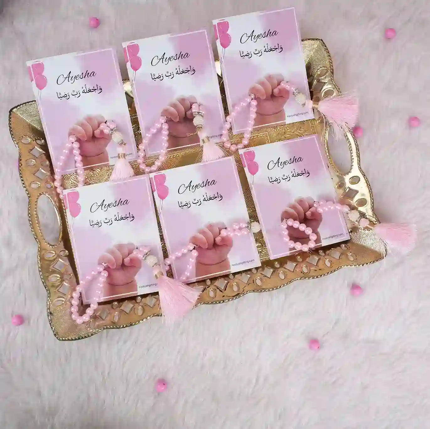 Set of six pink Little Hands Tasbeeh Keepsakes on a decorative tray, ideal for Aqiqah celebrations and religious gifting.