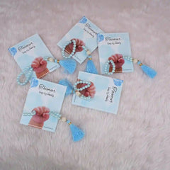 Five blue Little Hands Tasbeeh Keepsakes with personalized cards, ideal for Aqiqah gifting and religious ceremonies.