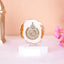 3" Ayatul Kursi Frame in white with golden flakes, ideal for Ramadan & EID home decor or Islamic gift. Displayed on a clear stand with floral accents.