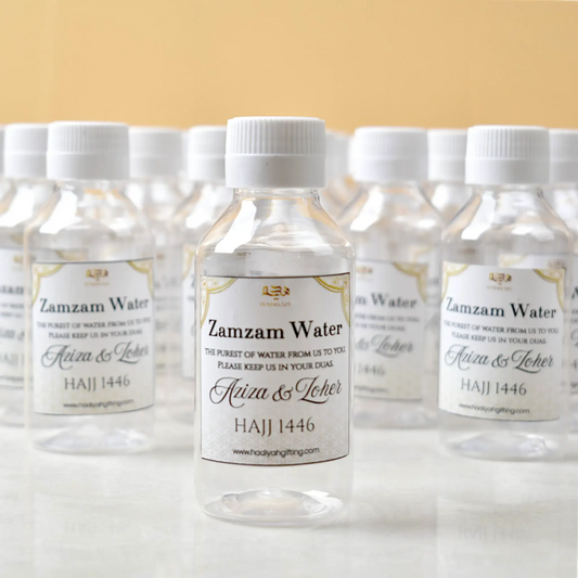 Zamzam Bottles 100ml Pack - Sacred Water Gifts featuring personalized Hajj 1446 labels, ideal for Umrah return gifts and Islamic celebrations.