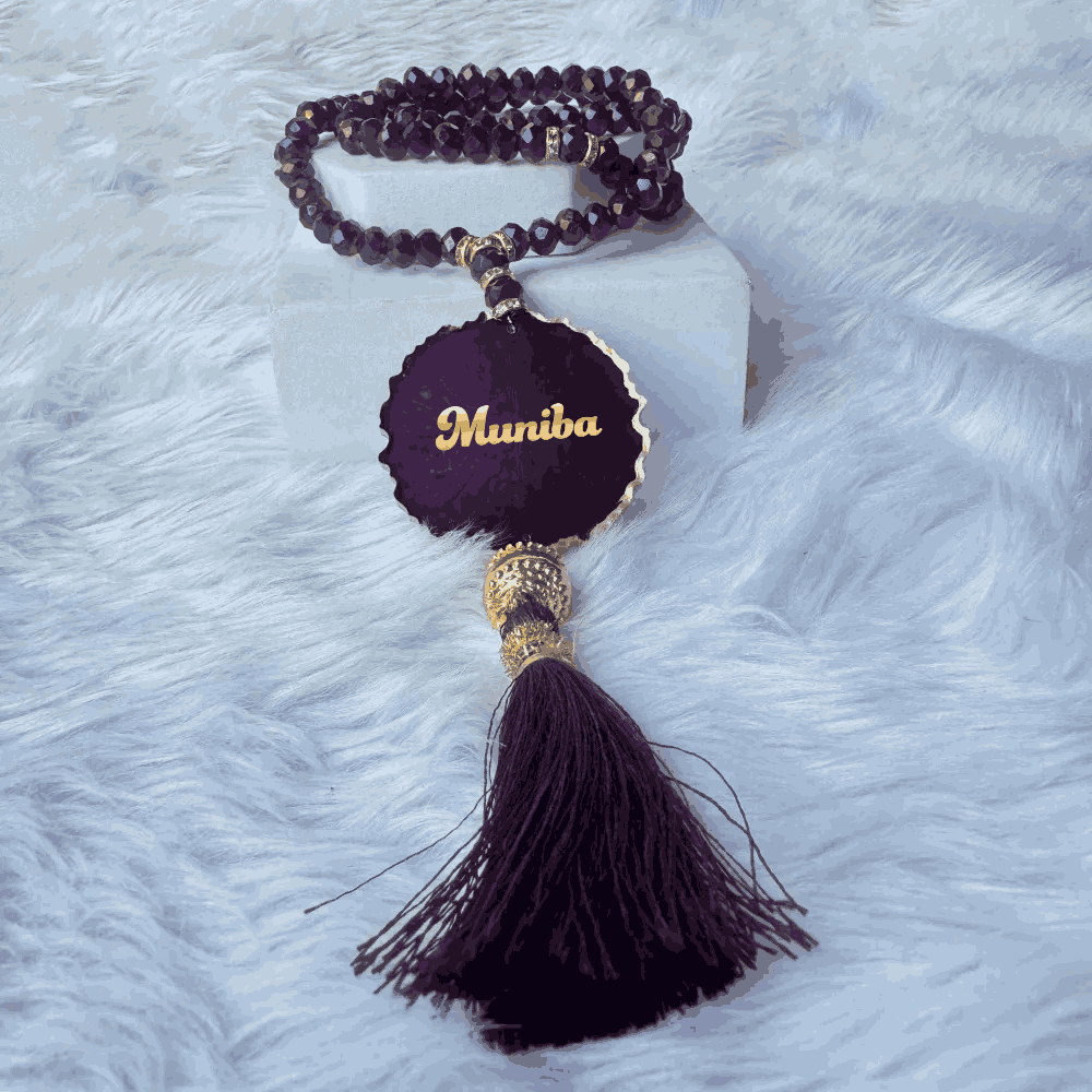 Personalized crystal tasbeeh with name 'Muniba' and tassel from the Customised Purple Salah Combo Hamper, perfect for gifting.