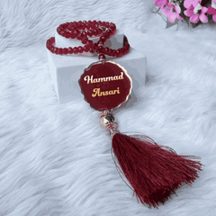 Maroon 100 Beads Crystal Tasbeeh with personalized name tag, ideal for Islamic prayer and gifting during Ramadan, Eid, or Hajj & Umrah.