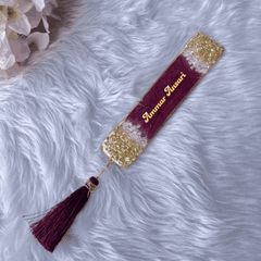 Custom name bookmark in maroon and gold with 'Ammar Ansari' text and tassel, ideal for Islamic wedding favors or personalized gifts.