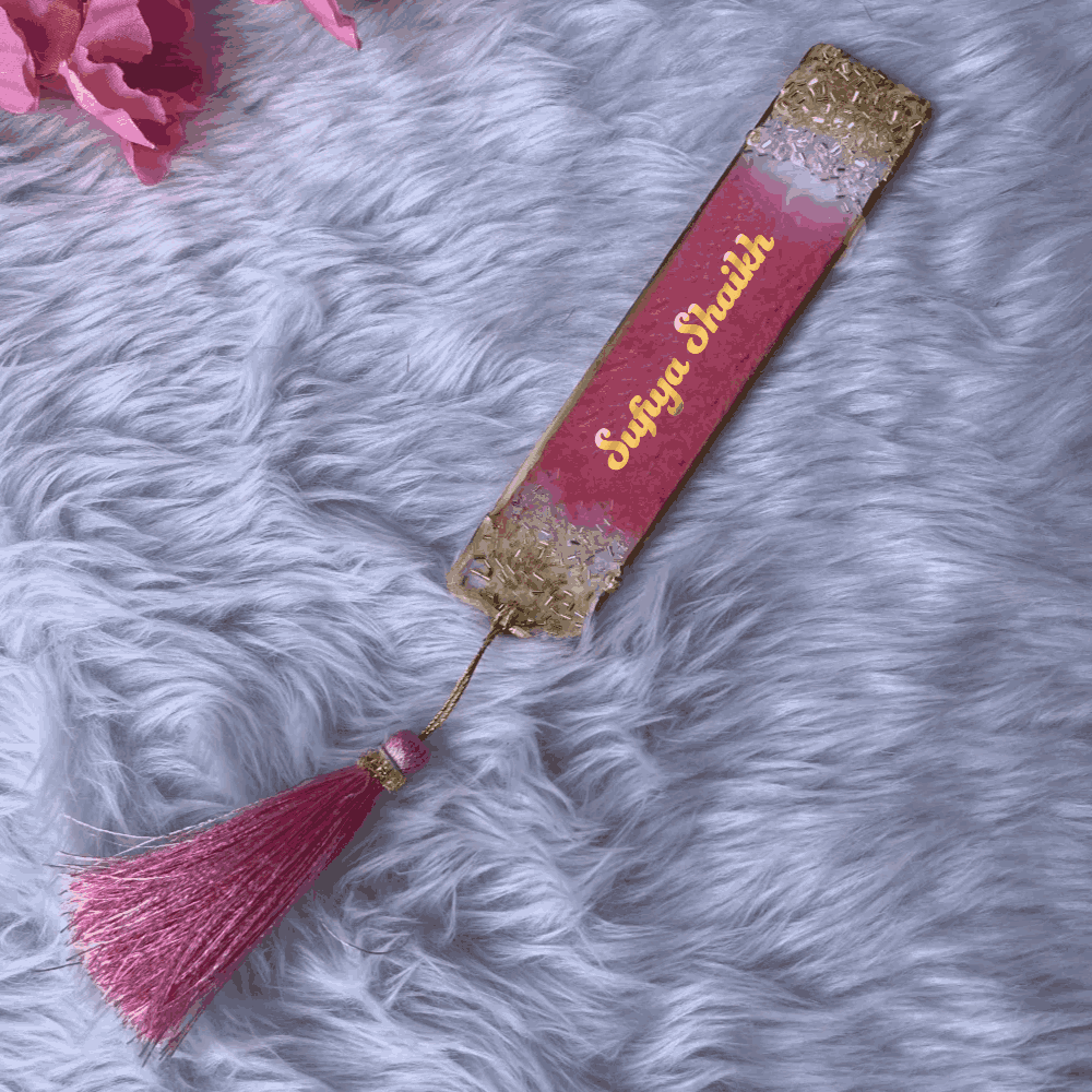 Personalized pink and gold resin bookmark with name 'Sufiya Shaikh' and pink tassel, designed for gifting and Islamic book accessories.