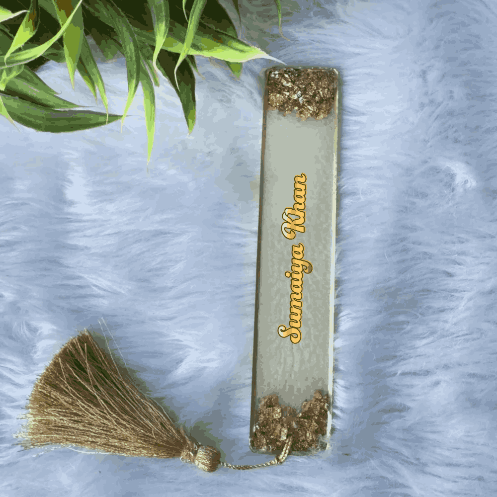 Elegant Islamic bookmark in white and gold resin with name 'Sumaiya Khan' and gold tassel, ideal for personalized wedding favors or gifts.