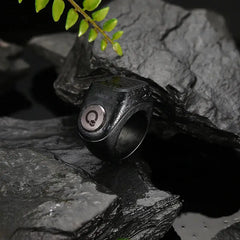 Waterproof black Zikr Ring Flex Pro placed on rocks, showcasing durable design for Islamic prayer and tasbih tracking.