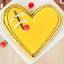 Butterscotch Heart Shape Cake with yellow caramel glaze, chocolate swirl design, and cherry topping. Ideal for romantic surprises and anniversaries.