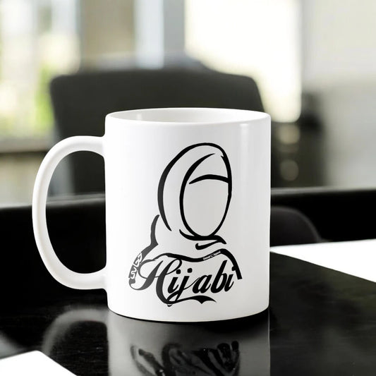 Hijabi Mug Ceramic featuring minimalist hijab illustration and 'Hijabi' text, symbolizing identity and strength. 350ml, microwave-safe drinkware.