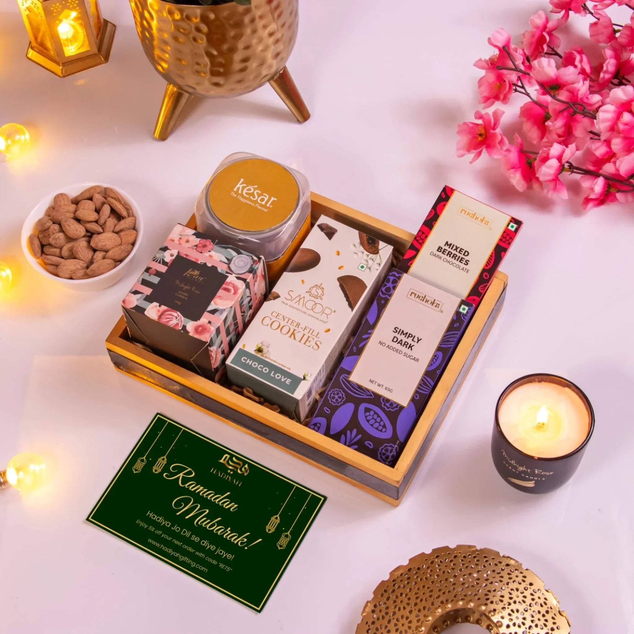 Luxury Ramadan gift basket with gourmet chocolates, cookies, and candles.