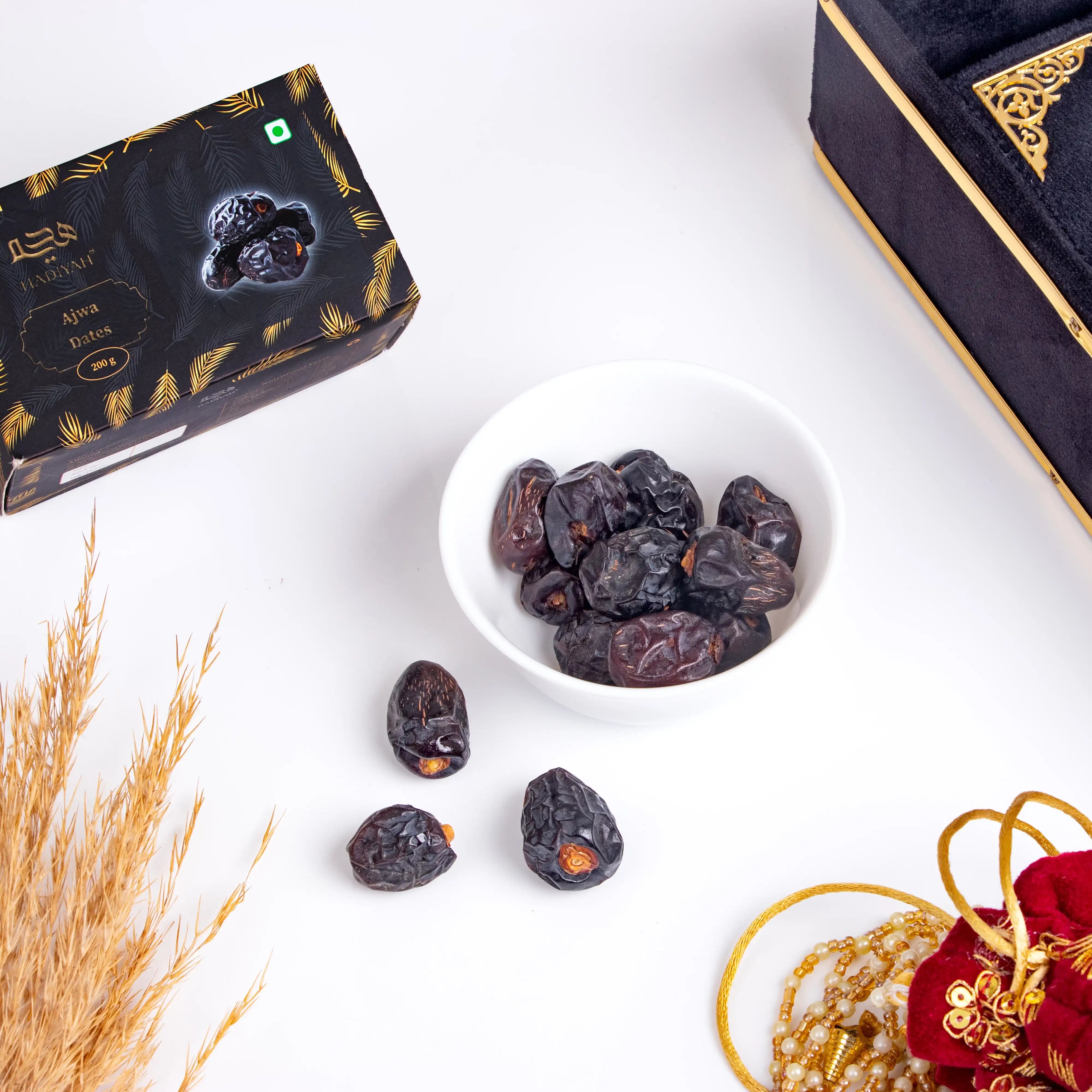 Premium Ajwa dates in bowl with luxury packaging and festive decor