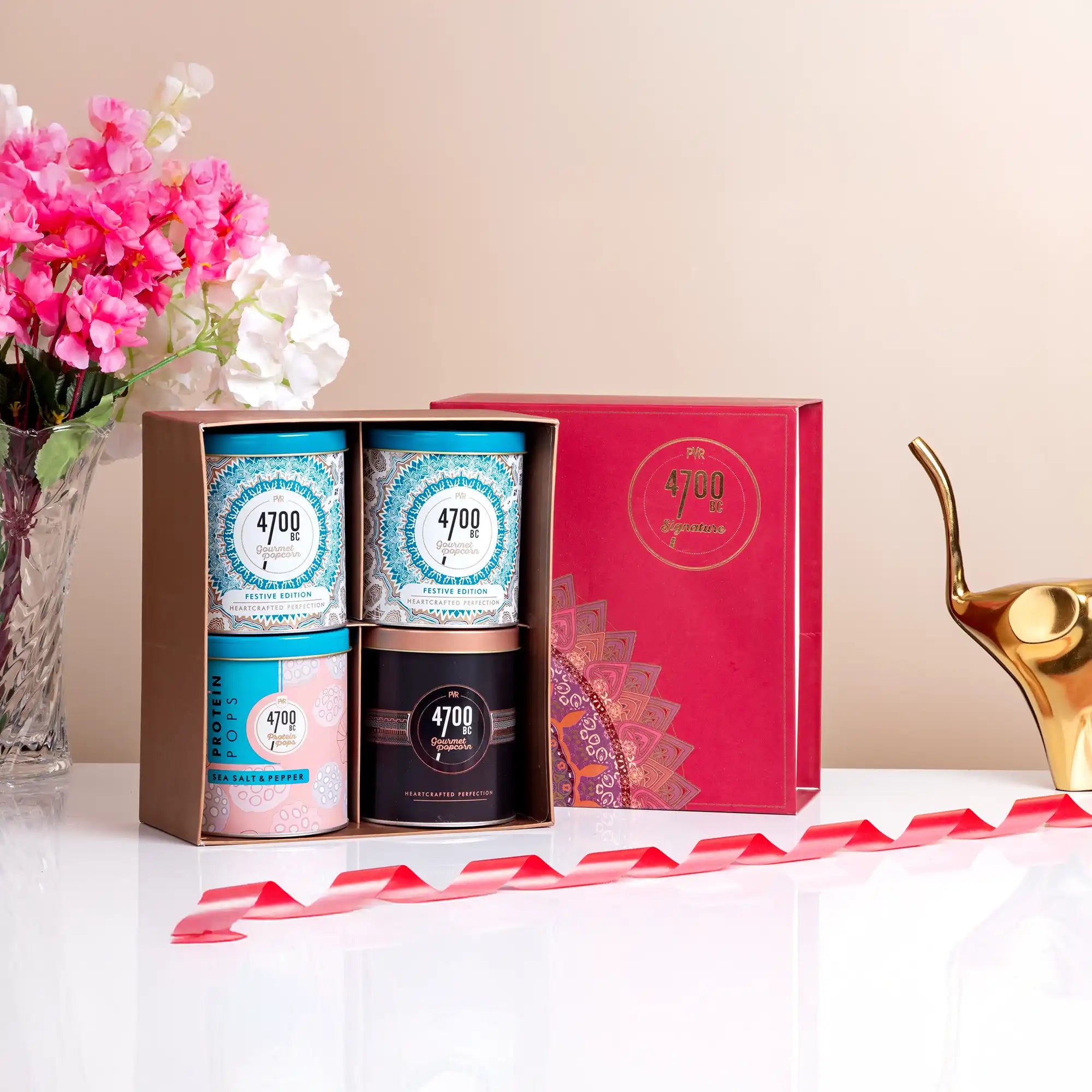 Elegant Ramadan gift box with gourmet popcorn tins for corporate gifting.