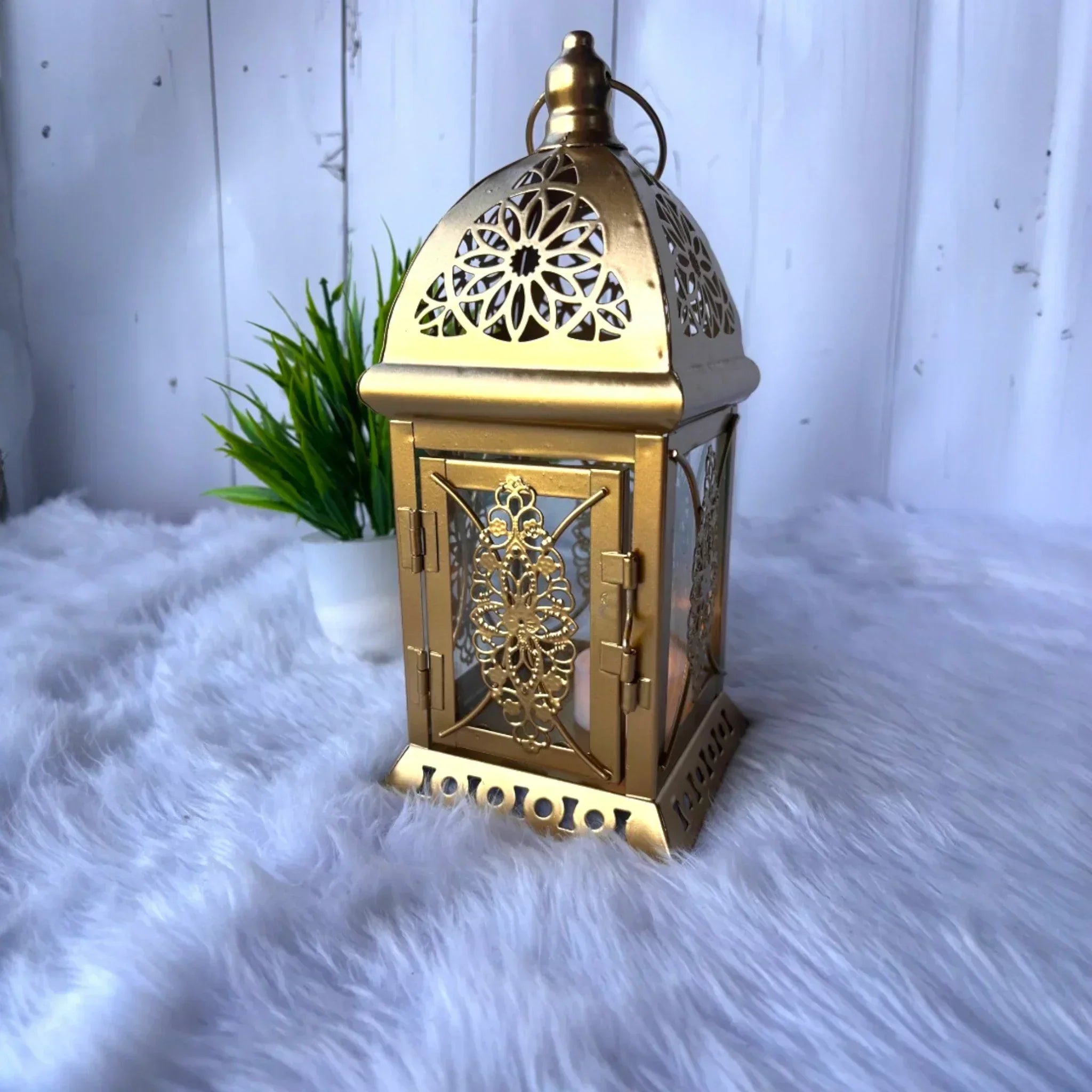 Elegant golden Middle Eastern lantern with intricate floral patterns.