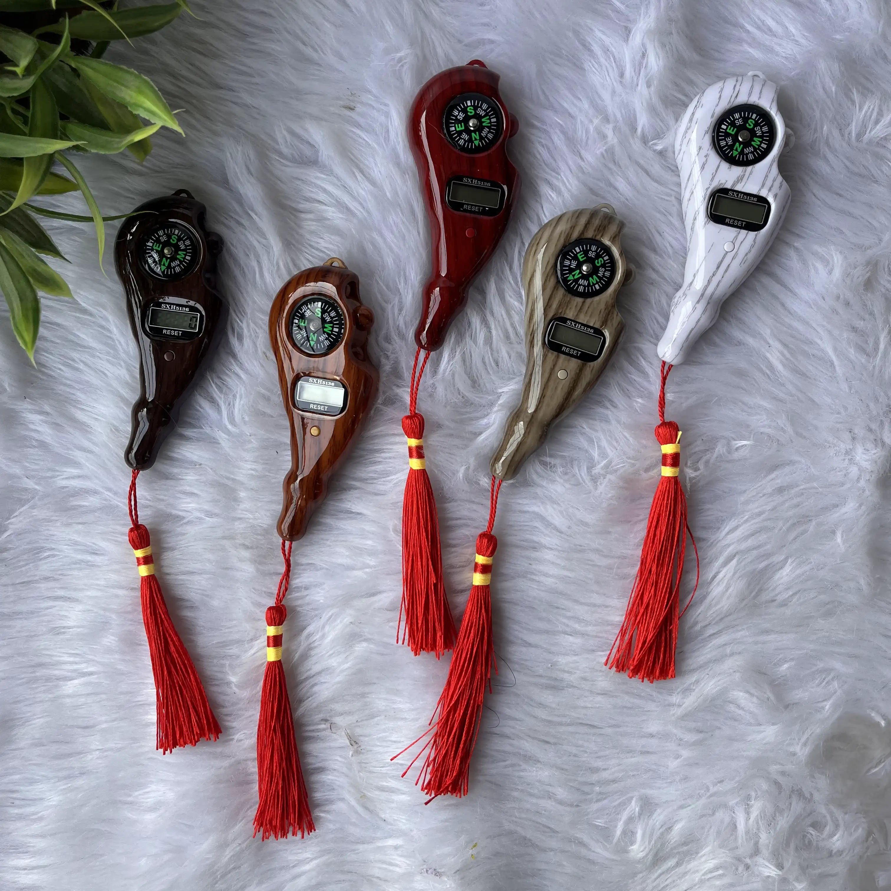 Elegant digital Tasbeeh counters with compass and red tassels on display