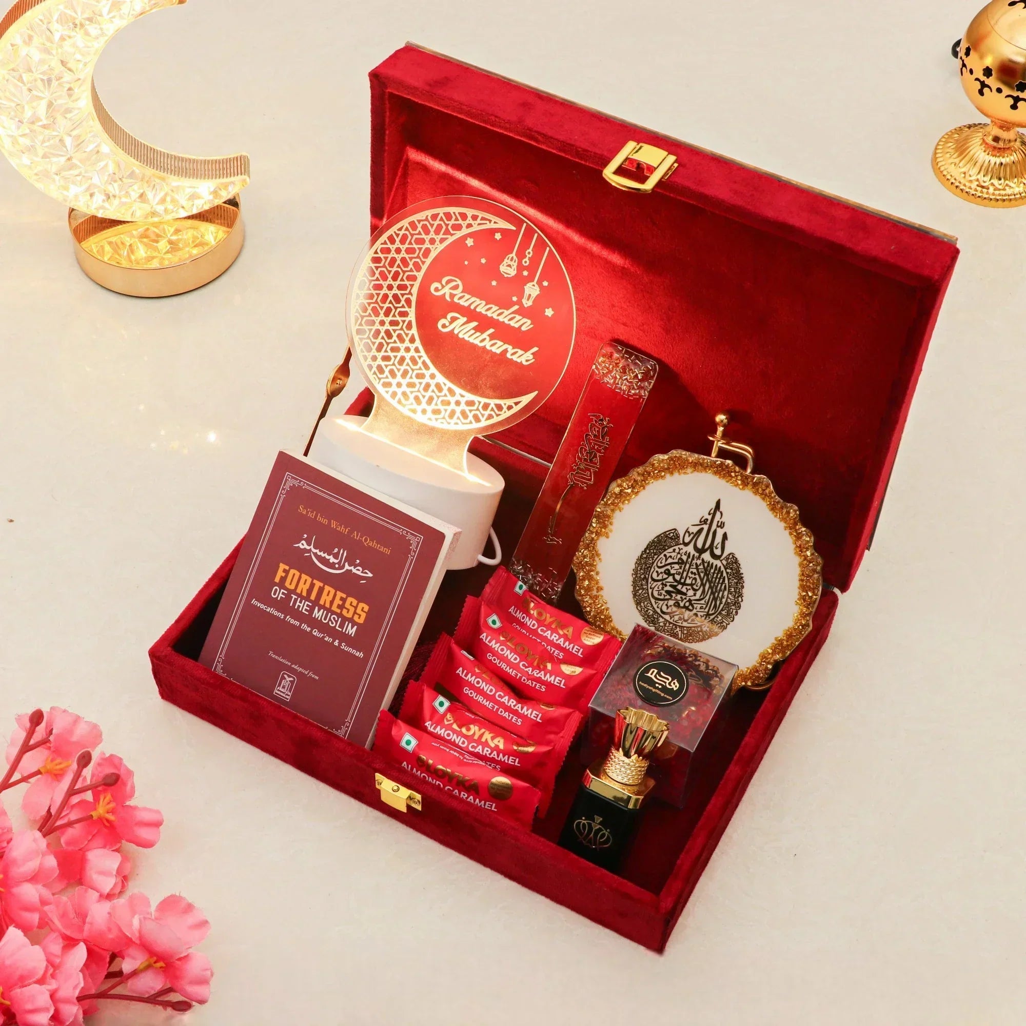 Elegant Ramadan gift box with Islamic decor, sweets, and prayer book.