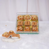 Baklava assortment in transparent gift box with nuts topping