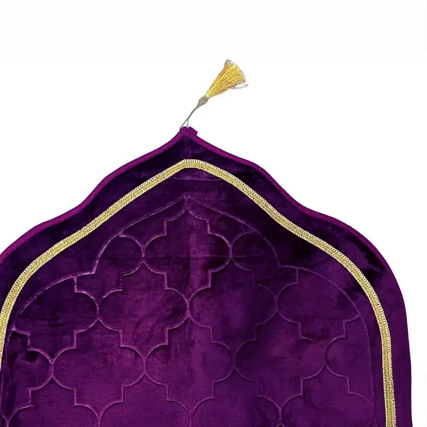 Close-up of Purple Dome Janamaz top with gold tassel and intricate velvet pattern, showcasing premium craftsmanship.