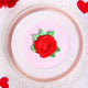 Top view of Vanilla Rose Cake featuring a red rose icing and green leaves on pink and white frosting, perfect for romantic celebrations.