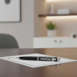 Black pen with silver accents on a white background