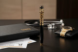 Purple lighter with a gold and silver cap on a white background